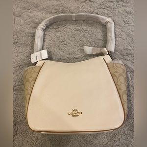 Brand new Coach purse in original packaging.
